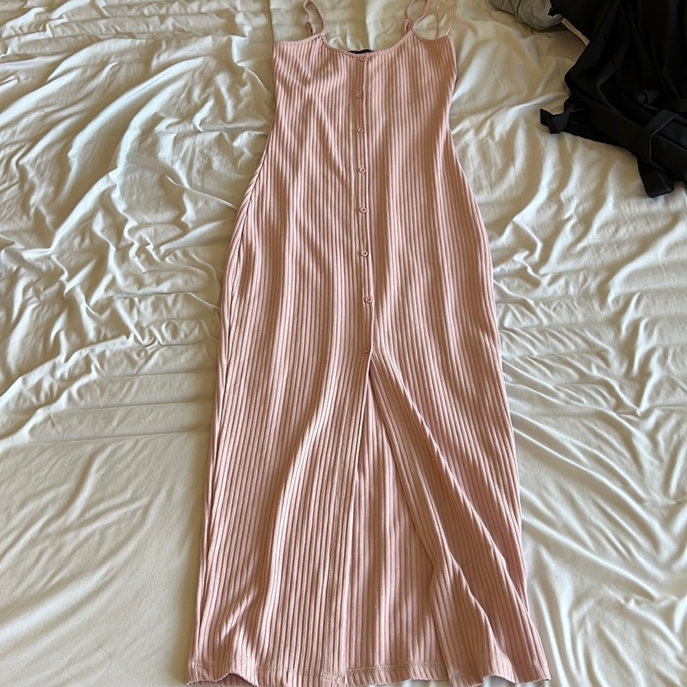 Baby pink stepped maxi dress with buttons and slit down the front.